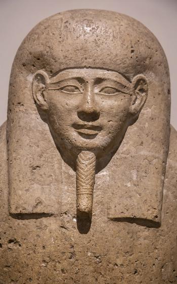 Ancient Egyptian stone sculpture of a face